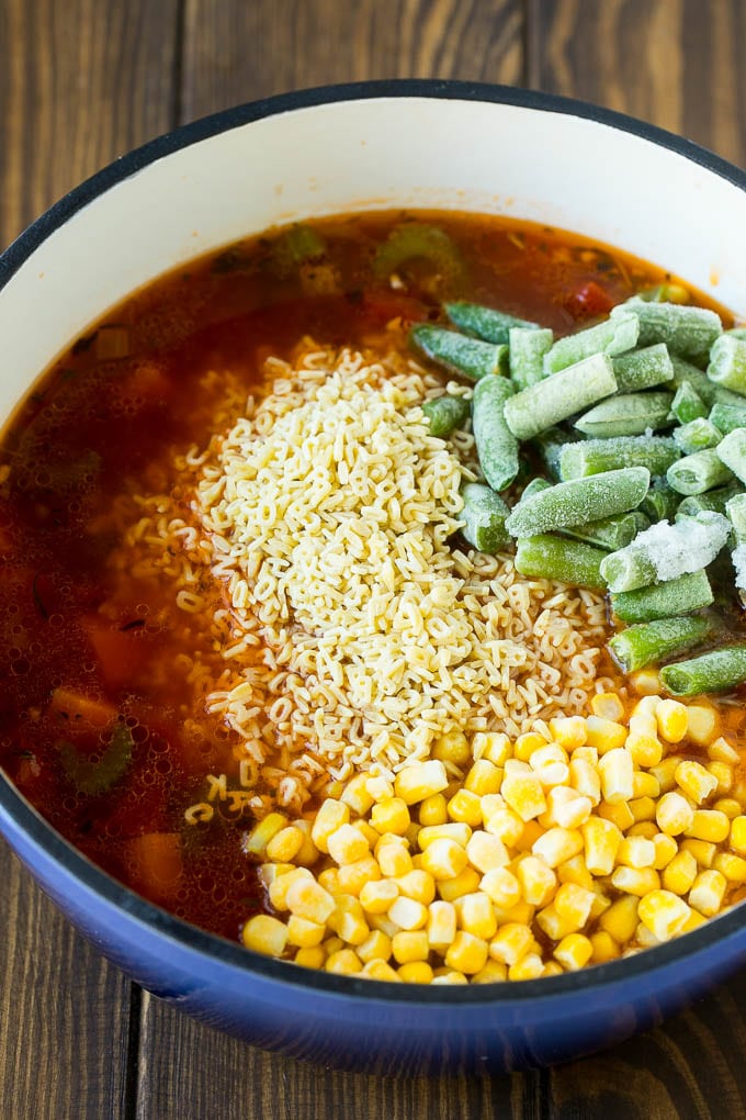 Alphabet Soup Recipe | Hamburger Soup | Beef and Vegetable Soup #soup #hamburger #noodles #dinner #ezlod #carrots A pot with noodles, broth, frozen corn and frozen green beans.