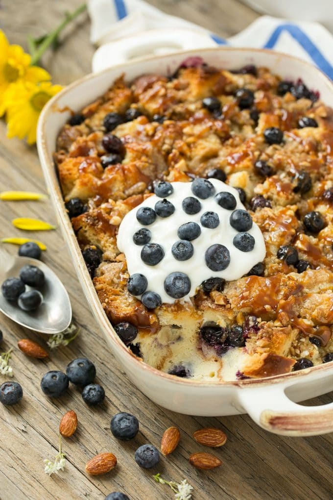 Blueberry Bread Pudding Recipe | Blueberry Bread Pudding | Easy Bread Pudding #blueberry #breadpudding #dessert #ezlod A pan of blueberry bread pudding topped with streusel and caramel sauce.