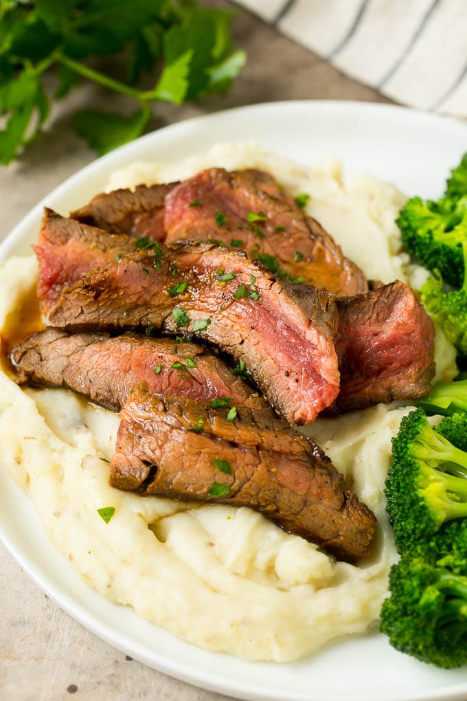 Flank Steak Marinade Recipe | Marinated Flank Steak | Marinated Steak | Steak Marinade #steak #beef #grilling #marinade #dinner #ezlod Beef slices served with mashed potatoes and broccoli.