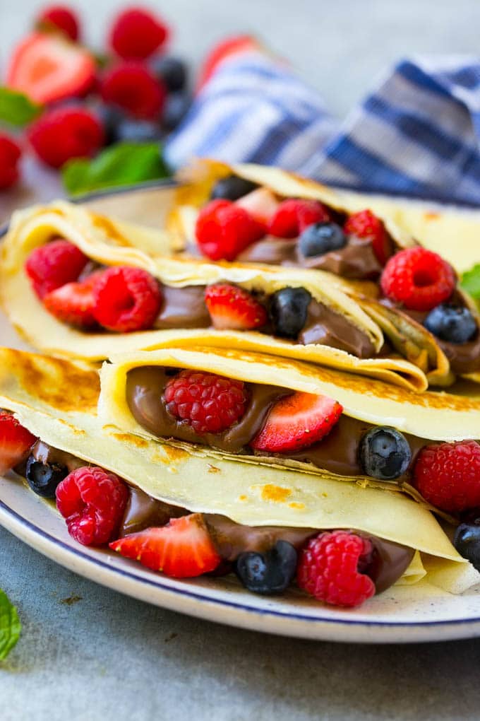 Nutella Crepes Recipe | Easy Crepes Recipe | Blender Crepes | Berry Crepes #crepes #nutella #nutellacrepes #blendercrepes #breakfast #ezlod A stack of crepes that are stuffed full of chocolate Nutella spread and fresh berries.