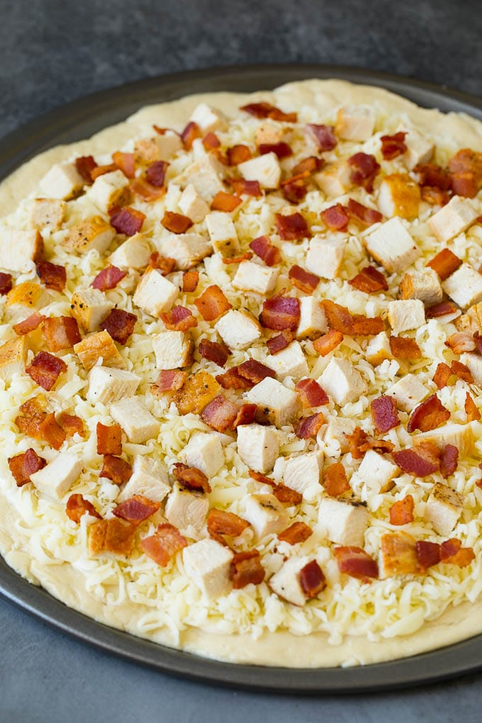 Chicken Alfredo Pizza Recipe #pizza #chicken #bacon #dinner #ezlod A crust topped with sauce, shredded cheese and meat.