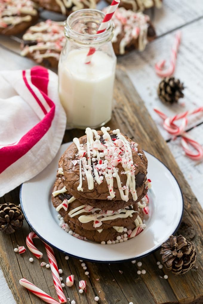 Peppermint Bark Cookie | Easy Peppermint Bark Cookies | Christmas Cookies | Peppermint Bark Cookies | Chocolate Peppermint Cookie #peppermint #peppermintbark #cookies #christmas #holiday #dessert #ezlod A plate of chocolate peppermint bark cookies with a bottle of milk on the side.