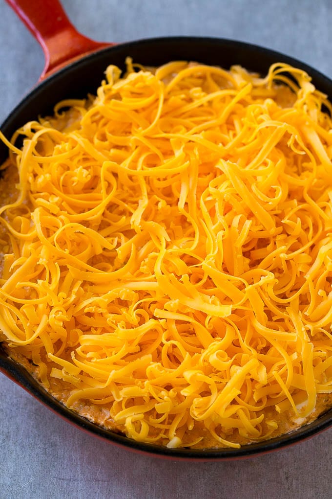 Buffalo Ranch Chicken Dip | Buffalo Chicken Dip | Baked Buffalo Dip | Cheesy Buffalo Dip #buffalowings #buffalochicken #dip #lowcarb #appetizer #ezlod Buffalo chicken dip topped with shredded cheddar cheese, ready to go into the oven.