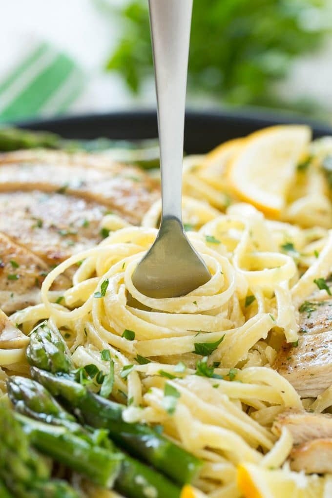 Lemon Asparagus Pasta with Grilled Chicken Recipe | Asparagus Pasta | Grilled Chicken Pasta | Easy Pasta Recipe #pasta #asparagus #lemon #chicken #dinner #ezlod A fork serving up a portion of creamy pasta.