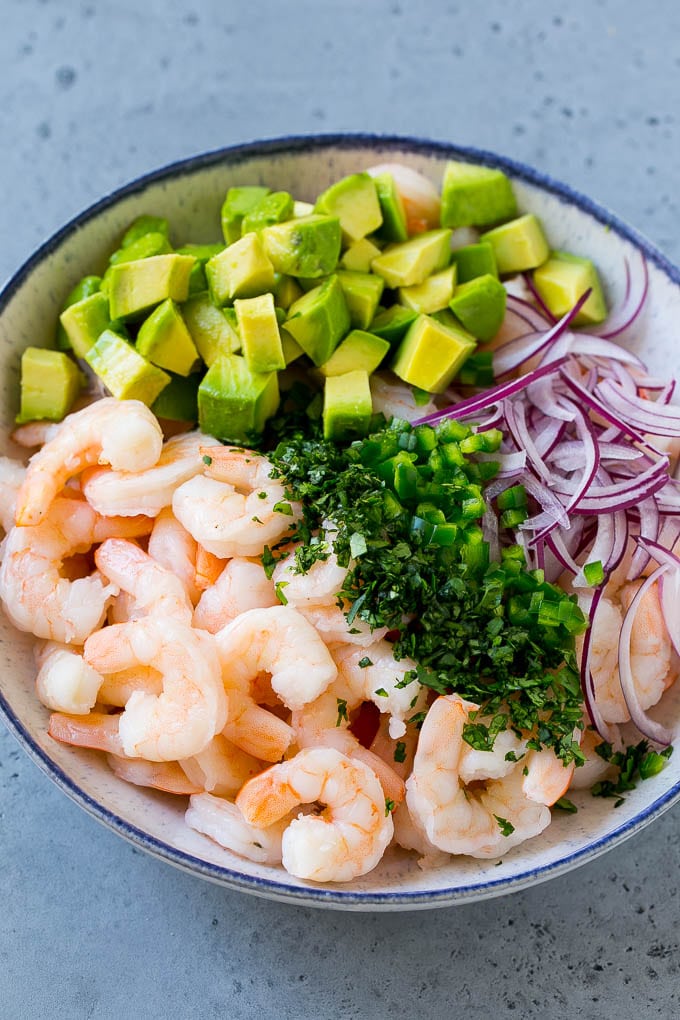 Mexican Shrimp Cocktail Recipe | Coctel de Camarones | Shrimp Cocktail | Mexican Shrimp #shrimp #appetizer #avocado #mexican #ezlod Shrimp, red onion, avocado, jalapeno and cilantro in a serving bowl.