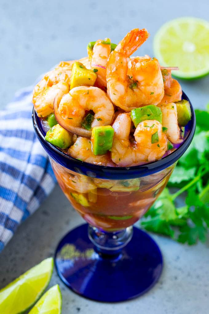 Mexican Shrimp Cocktail Recipe | Coctel de Camarones | Shrimp Cocktail | Mexican Shrimp #shrimp #appetizer #avocado #mexican #ezlod An individual cup of Mexican shrimp cocktail with red onion and avocado.