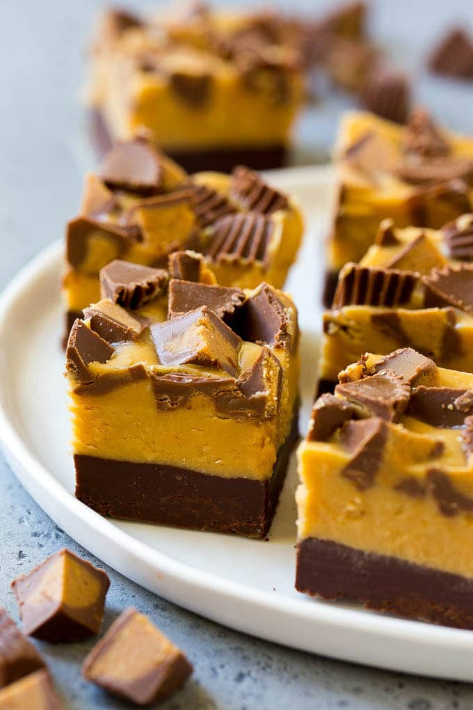Chocolate Peanut Butter Fudge Recipe | Peanut Butter Cup Fudge | Easy Fudge Recipe #chocolate #peanutbutter #fudge #baking #dessert #ezlod Squares of chocolate peanut butter fudge topped with peanut butter cups.