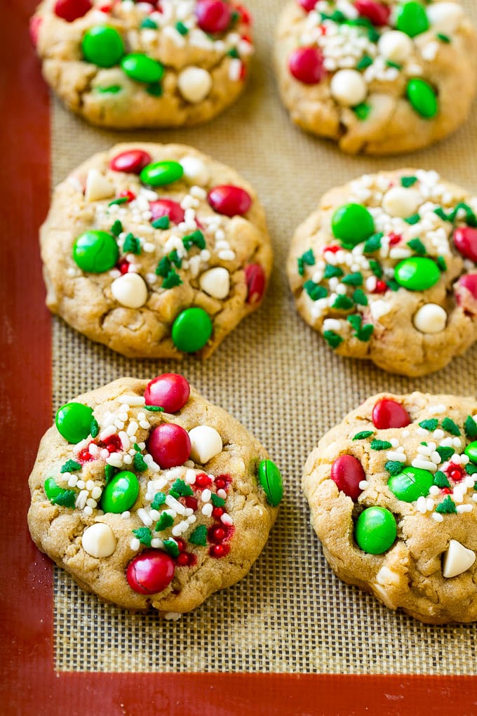 Christmas Monster Cookies Recipe | Oatmeal Cookies | Peanut Butter Cookies | M&M's Cookies #baking #cookies #dessert #peanutbutter #chocolate #ezlod #christmas #sprinkles Baked Christmas cookies on a sheet pan.