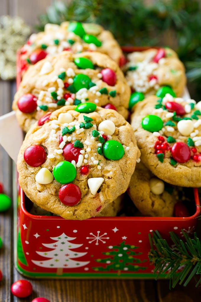 Christmas Monster Cookies Recipe | Oatmeal Cookies | Peanut Butter Cookies | M&M's Cookies #baking #cookies #dessert #peanutbutter #chocolate #ezlod #christmas #sprinkles Christmas monster cookies in a gift tin.