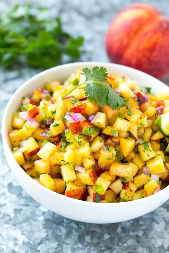 Peach Salsa | Fruit Salsa #peaches #salsa #dip #appetizer #ezlod Peach salsa in a bowl made with red onion, jalapeno and cilantro.