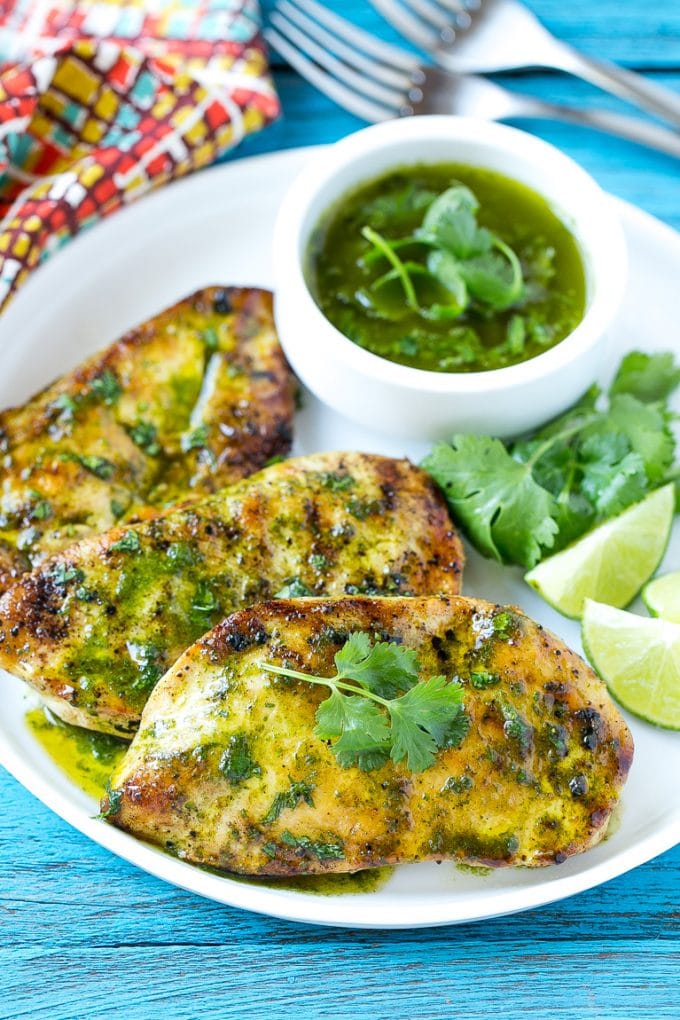 Cilantro Lime Chicken | Grilled Chicken #chicken #grilling #cilantro #lime #dinner #ezlod Cilantro lime chicken topped with sauce and served with lime wedges.