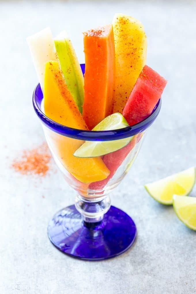 Mexican Fruit Cups | Fruit Cups | Mexican Fruit | Tropical Fruit #fruit #fruitcup #watermelon #pineapple #snack #healthy #ezlod Mexican fruit cups topped with chili lime seasoning.