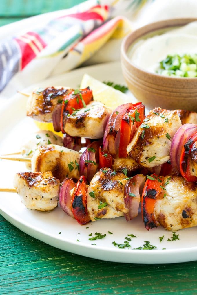 Greek Chicken Kabobs | Grilled Chicken Kabobs | Healthy Chicken Recipe | Greek Chicken #greekfood #chicken #grilling #grilledchicken #kabobs #dinner #ezlod A stack of Greek chicken skewers made with peppers and onions.