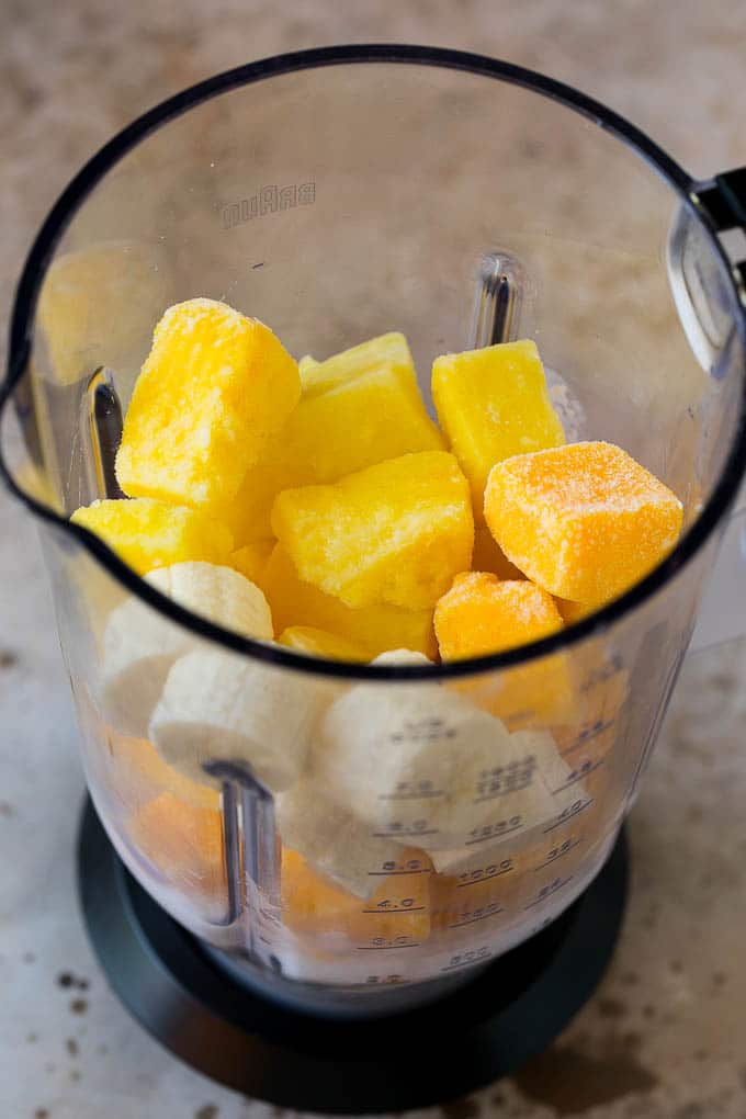 Tropical Smoothie Recipe | Mango Smoothie | Pineapple Smoothie #smoothie #mango #pineapple #banana #drink #ezlod Pineapple, mango, banana and coconut milk in a blender.