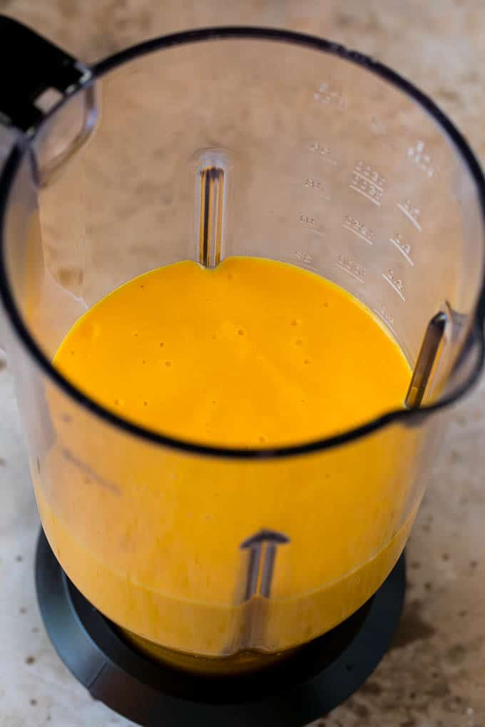 Tropical Smoothie Recipe | Mango Smoothie | Pineapple Smoothie #smoothie #mango #pineapple #banana #drink #ezlod A smoothie inside of a blender.