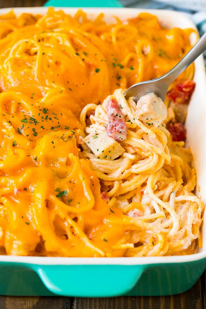 Chicken Spaghetti Recipe | Baked Spaghetti #pasta #spaghetti #chicken #cheese #casserole #dinner #ezlod A fork serving up a portion of creamy chicken spaghetti.