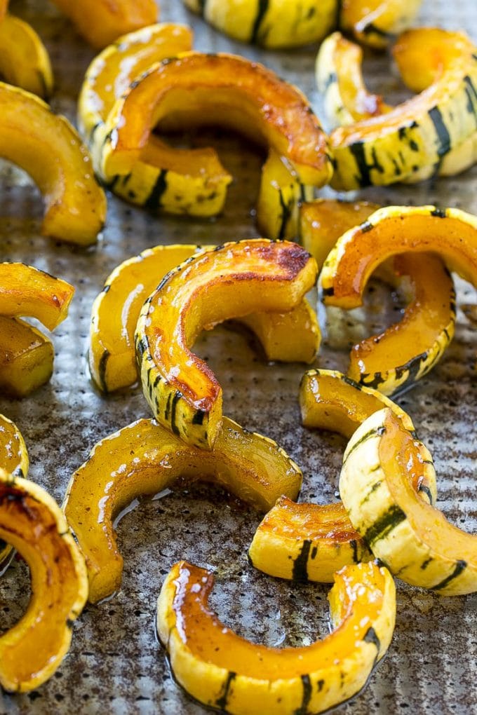Brown Sugar Delicata Squash Recipe | Roasted Squash | Delicata Squash | Winter Squash Recipe #squash #wintersquash #brownsugar #sidedish #delicatasquash #dinner #ezlod Roasted delicata squash on a sheet pan seasoned with brown sugar.