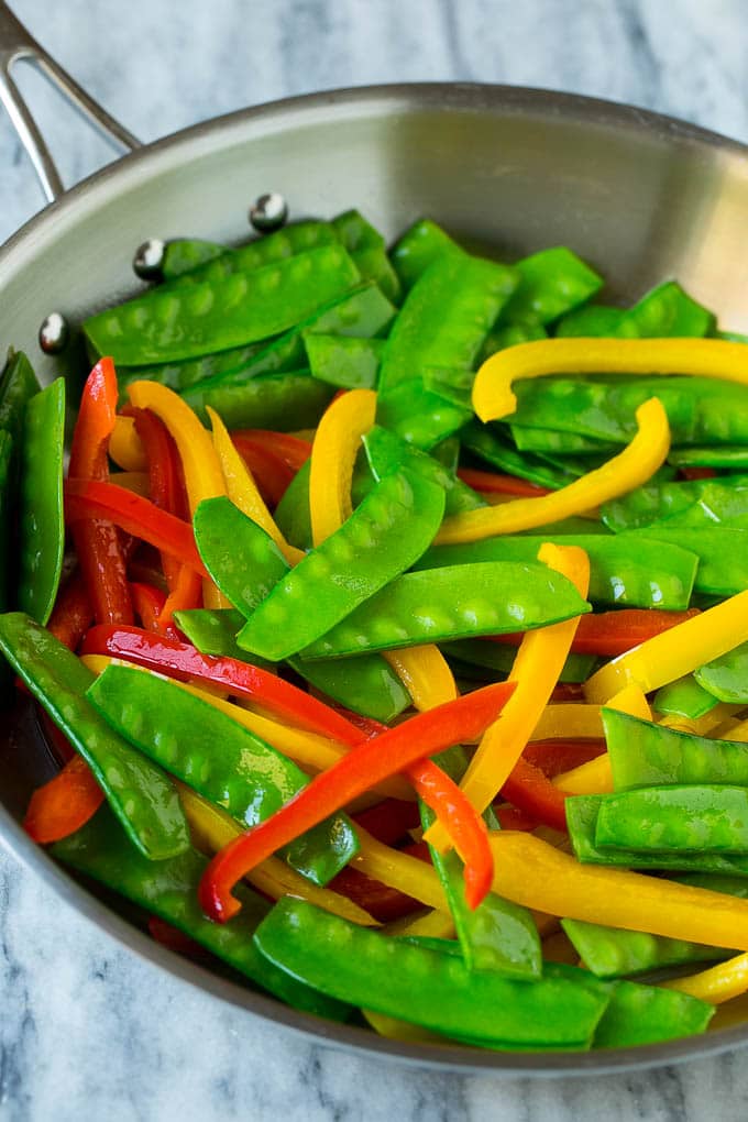 Teriyaki Shrimp Stir Fry Recipe | Shrimp Stir Fry | Healthy Stir Fry #shrimp #teriyaki #vegetables #stirfry #dinner #ezlod Cooked snow peas and bell peppers in a skillet.