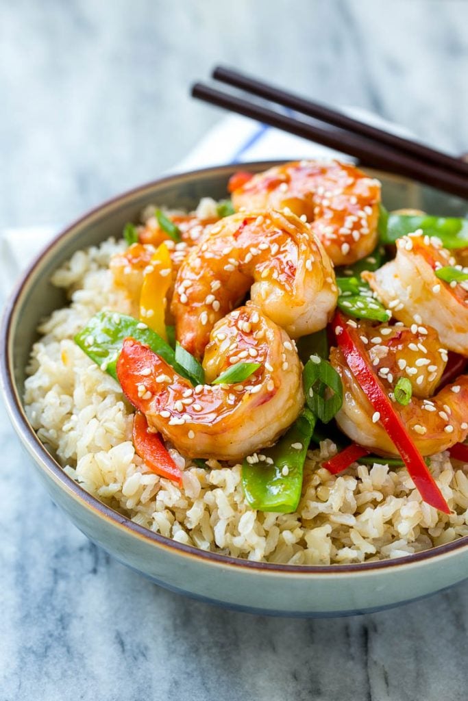 Teriyaki Shrimp Stir Fry Recipe | Shrimp Stir Fry | Healthy Stir Fry #shrimp #teriyaki #vegetables #stirfry #dinner #ezlod A bowl of shrimp stir fry and vegetables garnished with sesame seeds.