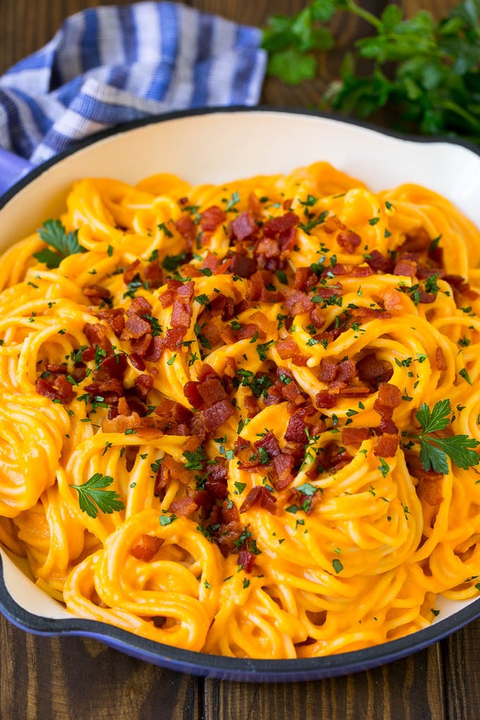 Butternut Squash Pasta Recipe #pasta #squash #bacon #fall #dinner #ezlod Butternut squash pasta in a skillet topped with bacon and parsley.