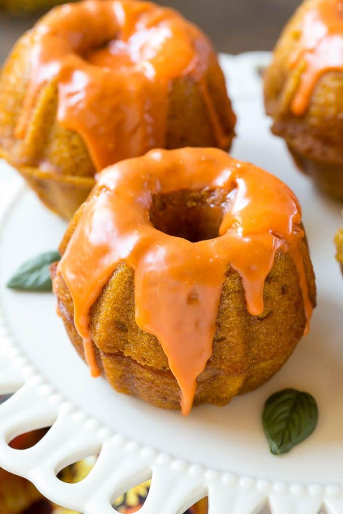 Pumpkin Spice Cake Recipe | Pumpkin Cake | Easy Pumpkin Cake | Thanksgiving Dessert #thanksgiving #pumpkin #cake #pumpkincake #spicecake #dessert #ezlod #holiday Two bundt cakes stacked together with orange colored ganache on top.