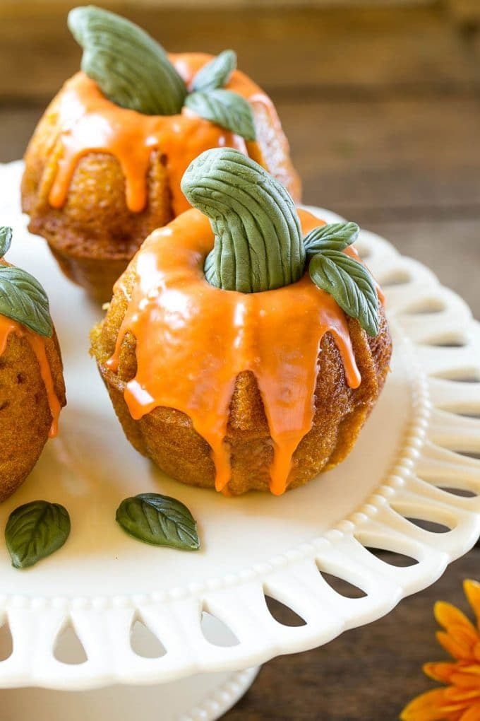 Pumpkin Spice Cake Recipe | Pumpkin Cake | Easy Pumpkin Cake | Thanksgiving Dessert #thanksgiving #pumpkin #cake #pumpkincake #spicecake #dessert #ezlod #holiday A platter of pumpkin spice cakes decorated like pumpkins.