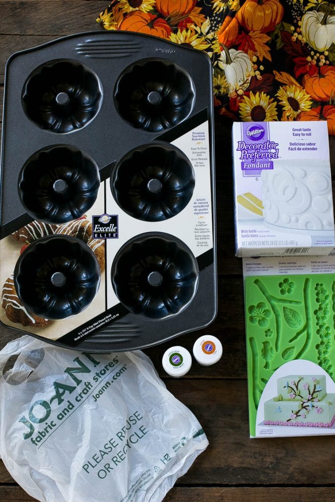 Pumpkin Spice Cake Recipe | Pumpkin Cake | Easy Pumpkin Cake | Thanksgiving Dessert #thanksgiving #pumpkin #cake #pumpkincake #spicecake #dessert #ezlod #holiday Cake making tools including fondant, a cake pan, tubs of gel food color and fondant molds.