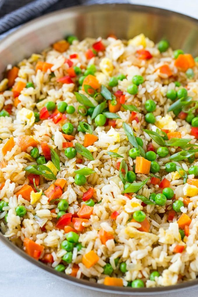 Veggie Fried Rice Recipe | Vegetarian Fried Rice | Easy Fried Rice Recipe | Chinese Food #rice #friedrice #veggie #vegetarian #sidedish #ezlod A skillet of vegetarian fried rice with eggs, peas, carrots and peppers.