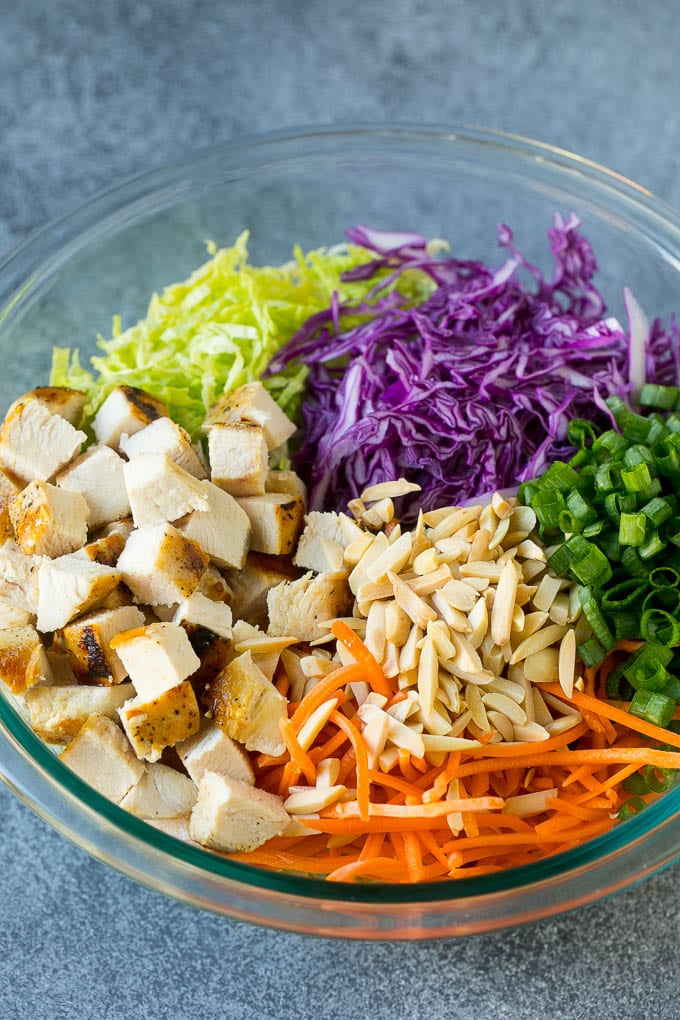 Chinese Chicken Salad Recipe | Asian Chicken Salad #salad #chicken #chickensalad #cabbage #lunch #dinner #ezlod Cabbage, carrots, chicken, almonds and green onions in a bowl.