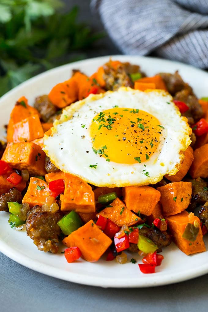 Sweet Potato Hash #sweetpotato #sausage #breakfast #brunch #ezlod Sweet potato hash with sausage, topped with a fried egg.