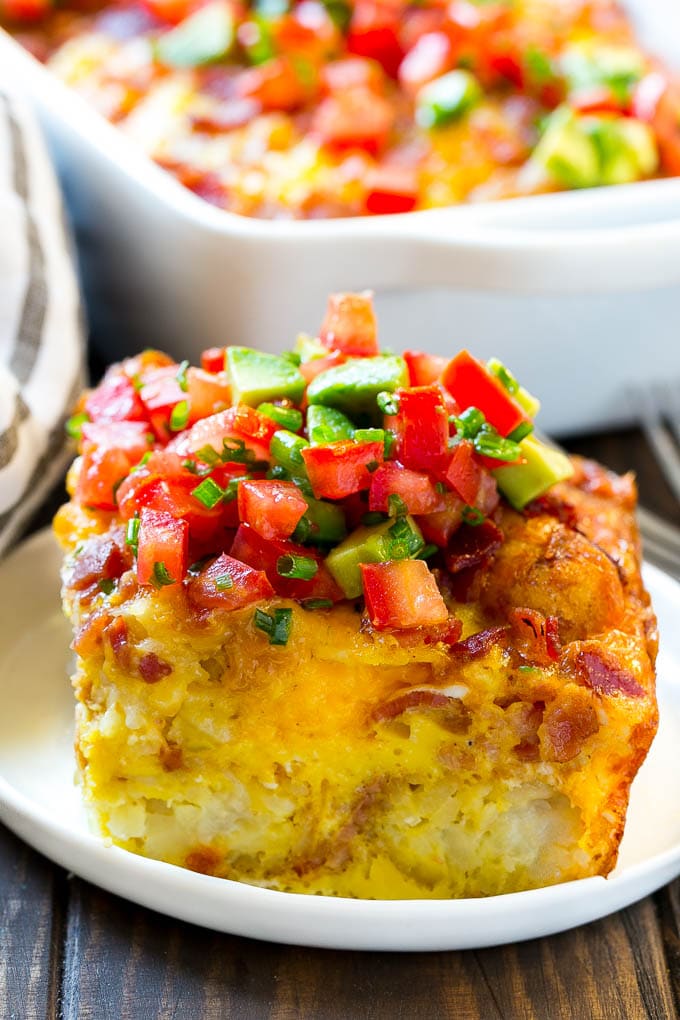 Breakfast Casserole with Bacon Recipe | Bacon and Egg Casserole | Egg Casserole with Bacon | Bacon Breakfast Casserole #eggs #bacon #casserole #breakfast #brunch #ezlod A slice of egg casserole with potato tots in it.