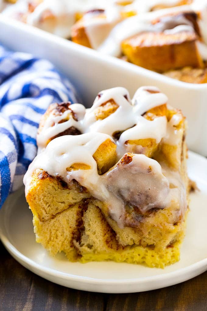 Cinnamon Roll French Toast Casserole | Cinnamon Roll French Toast Bake | Cinnamon Roll French Toast | Cinnamon French Toast #casserole #frenchtoast #cinnamonrolls #breakfast #ezlod A slice of baked casserole topped with frosting.