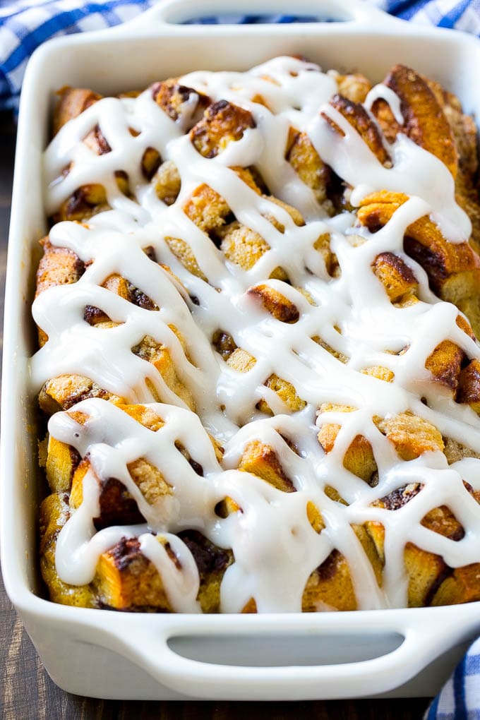 Cinnamon Roll French Toast Casserole | Cinnamon Roll French Toast Bake | Cinnamon Roll French Toast | Cinnamon French Toast #casserole #frenchtoast #cinnamonrolls #breakfast #ezlod A cinnamon roll french toast casserole in a baking dish, topped with icing.