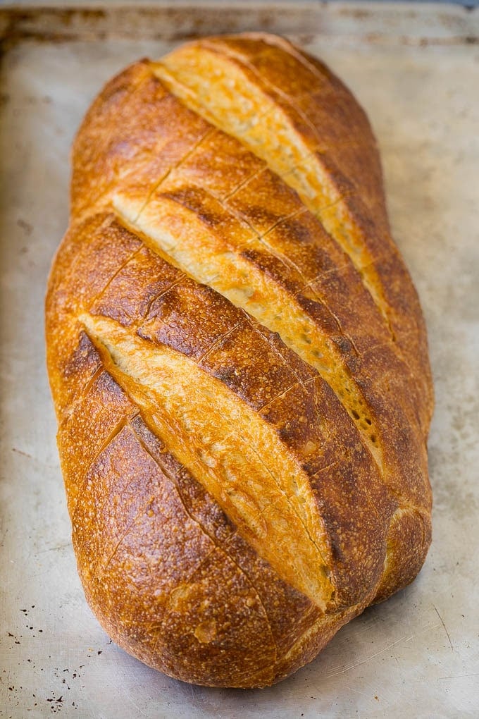 Pull Apart Bread | Garlic Bread | Cheese Bread #bread #garlic #cheese #sidedish #appetizer #ezlod A loaf of bread on a sheet pan with diagonal cuts in it.