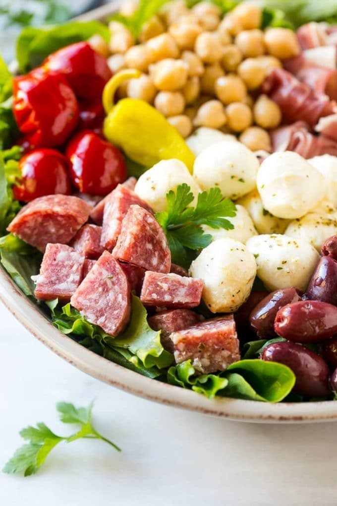 Antipasto Salad Recipe | Italian Salad | Main Course Salad | Antipasto Recipe #salad #salami #italianfood #dinner #lunch #ezlod A bed of greens topped with antipasto salad including meats, cheeses, beans and vegetables.