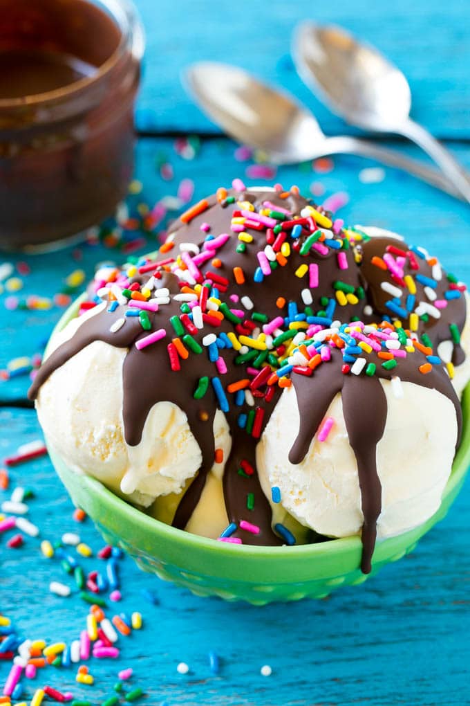 Homemade Magic Shell Recipe | Chocolate Ice Cream Topping | Chocolate Sauce | Hard Chocolate Coating #chocolate #icecream #dessert #ezlod Magic shell over vanilla ice cream with rainbow sprinkles.