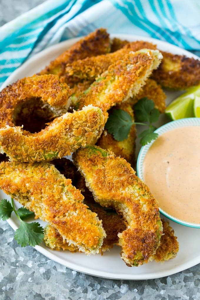 Avocado Fries Recipe | Fried Avocado | Avocado Fritters #avocado #appetizer #snack #ezlod A plate of avocado fries served with dipping sauce.