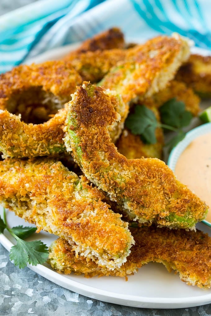 Avocado Fries Recipe | Fried Avocado | Avocado Fritters #avocado #appetizer #snack #ezlod A plate of avocado fries garnished with fresh cilantro.