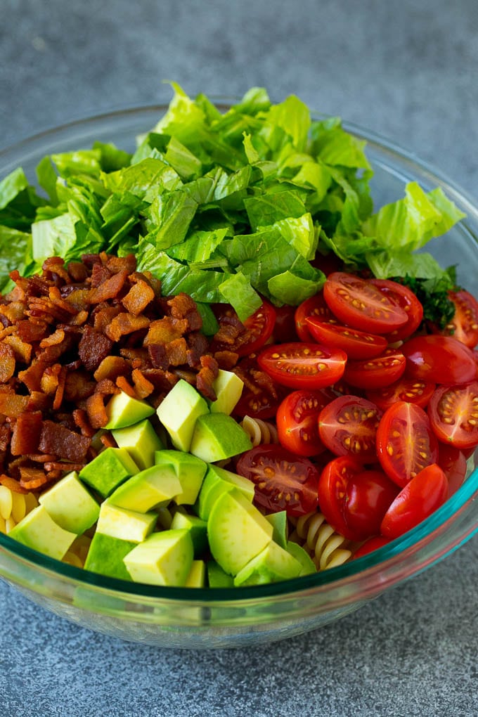 BLT Pasta Salad Recipe | Easy Pasta Salad | Bacon Pasta Salad #salad #pasta #blt #bacon #avocado #dinner #ezlod Bacon, lettuce, tomato, pasta and avocado in a bowl.