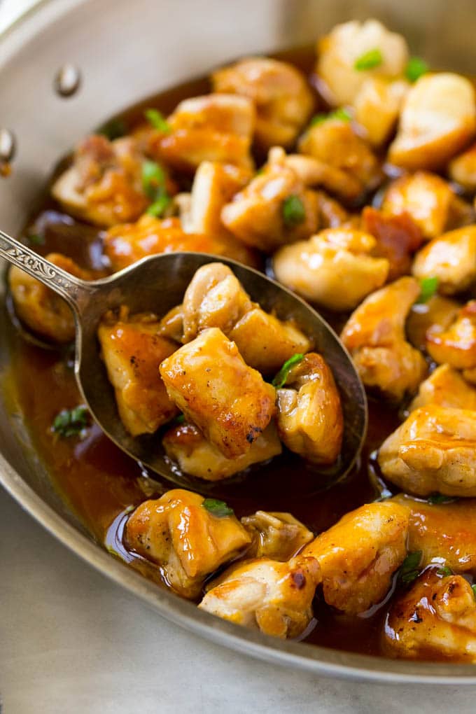 Bourbon Chicken | Sauteed Chicken | Chicken Stir Fry | Easy Chicken Recipe #chicken #dinner #ezlod A pan of bourbon chicken with a serving spoon in it.
