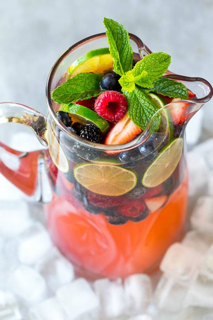 Berry Champagne Punch Recipe | Champagne Cocktail | Lime Cocktail | Berry Punch | Champagne Recipe #champagne #punch #berries #drink #ezlod A pitcher of champagne punch filled with fresh berries and mint sprigs.