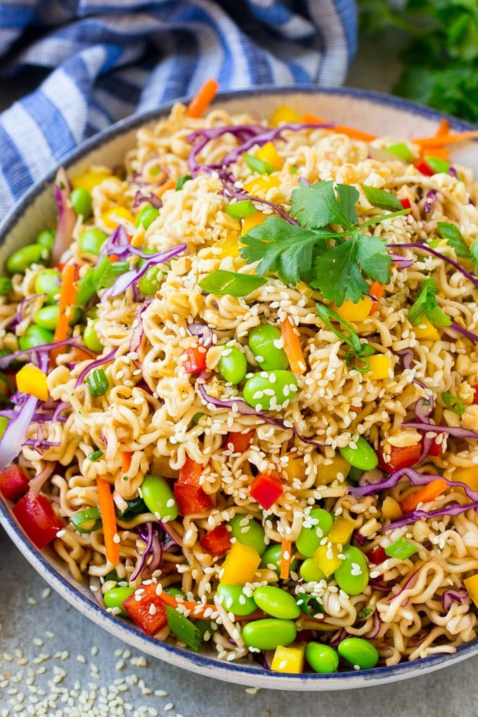 Asian Noodle Salad Recipe | Ramen Noodle Salad | Asian Salad #salad #noodles #edamame #vegetarian #ezlod #lunch A bowl of Asian noodle salad with colorful vegetables.
