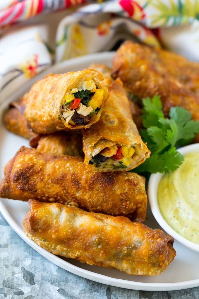 Southwestern Egg Rolls Recipe | Easy Egg Roll Recipe | Mexican Appetizer | Egg Roll Recipe | Southwest Egg Rolls #eggrolls #appetizer #chicken #snack #ezlod Morsels stuffed with diced chicken, bell peppers, black beans and cheese on a serving plate.