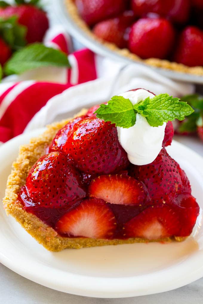 No Bake Strawberry Pie Recipe | Fresh Strawberry Pie | Strawberry Pie Recipe | No Bake Pie Recipe #strawberry #strawberrypie #nobake #nobakepie #dessert #ezlod A slice of no bake fresh strawberry pie with whipped cream on top.