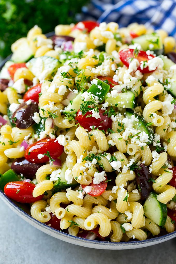 Greek Pasta Salad | Easy Pasta Salad | Vegetable Pasta Salad #pasta #salad #greek #cucumber #tomato #vegetarian #dinner #ezlod A bowl of Greek pasta salad loaded with feta cheese, olives, tomatoes, cucumber and bell peppers.
