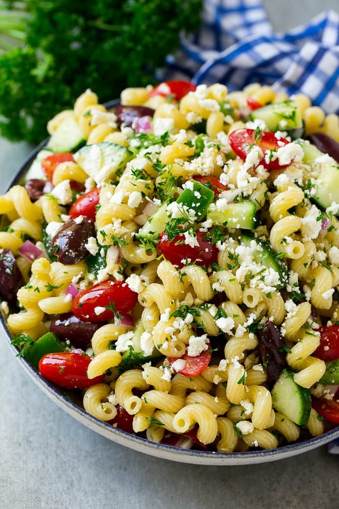 Greek Pasta Salad | Easy Pasta Salad | Vegetable Pasta Salad #pasta #salad #greek #cucumber #tomato #vegetarian #dinner #ezlod Greek pasta salad in a serving bowl, garnished with parsley.