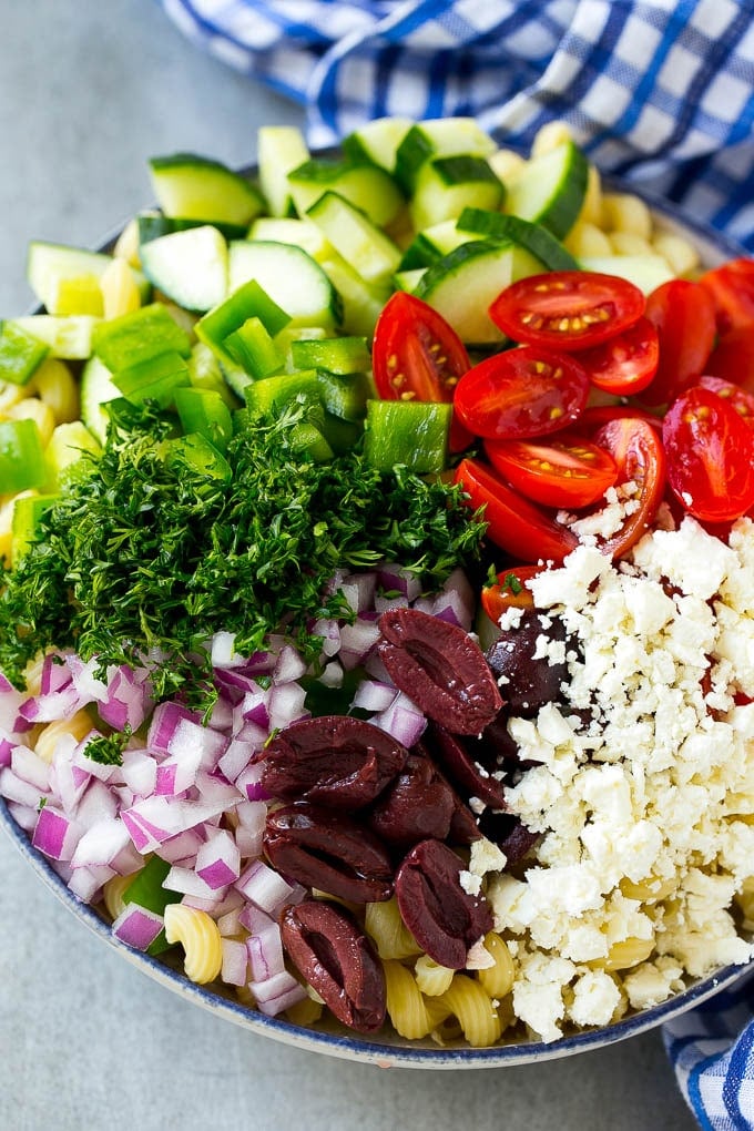 Greek Pasta Salad | Easy Pasta Salad | Vegetable Pasta Salad #pasta #salad #greek #cucumber #tomato #vegetarian #dinner #ezlod Cherry tomatoes, bell pepper, olives, feta, herbs and cucumbers over pasta.