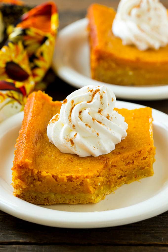 Pumpkin Gooey Butter Cake Recipe | Pumpkin Cake Recipe | Gooey Butter Cake | Pumpkin Dessert | Thanksgiving Dessert #pumpkin #cake #pumpkincake #gooeybuttercake #dessert #ezlod A slice of pumpkin butter cake with a bite taken out of it.