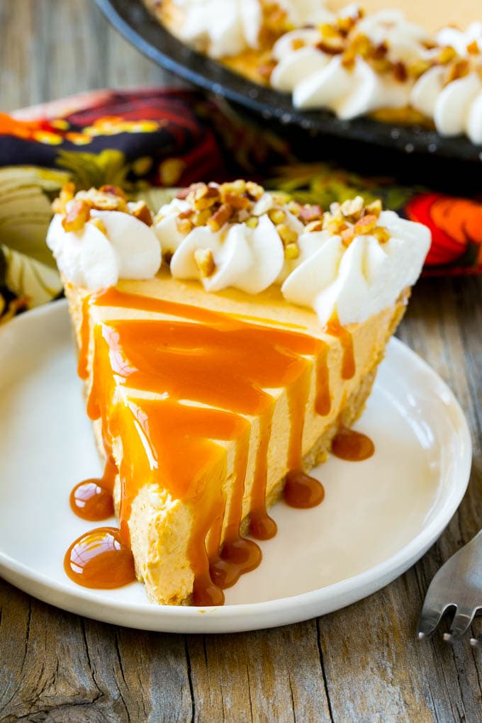 No Bake Pumpkin Cheesecake Recipe | Pumpkin Cheesecake | No Bake Cheesecake | Thanksgiving Dessert | Pumpkin Dessert #nobake #cheesecake #pumpkin #pumpkinpie #pumpkincheesecake #nobakecheesecake #dessert #ezlod A slice of cheesecake topped with a caramel drizzle.