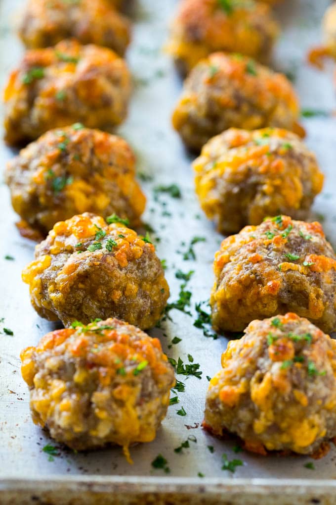 Sausage Cheese Balls Recipe | Sausage Balls Recipe | Bisquick Sausage Balls #sausage #sausageballs #balls #appetizer #cheeseballs #ezlod Cooked meatballs on a baking sheet.